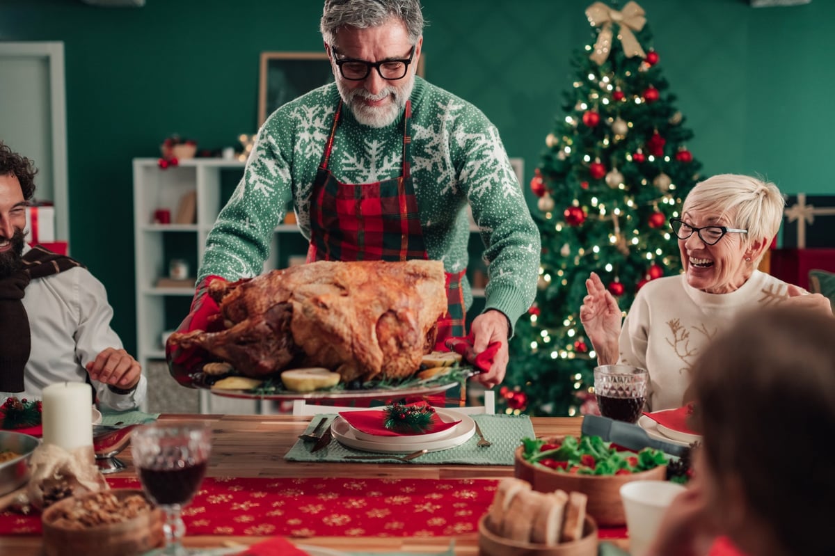 A roasted whole turkey on a platter, ready to carve for a family dinner
