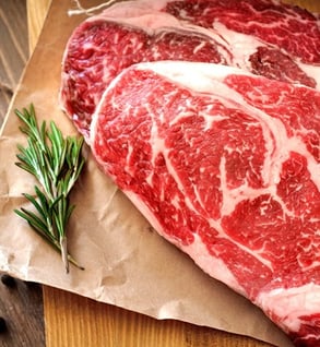The Butcher's Choice — ribeyes, filet mignon, a whole brisket, ground beef, sausage, bacon, chicken, and snack sticks from Little Blue's Farm